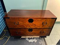 Front view showing two drawers, hardware and wood grain