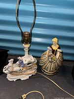 Overall view of porcelain carriage lamp and ceramic lady figurine