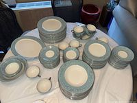 Top view showing full assortment of stacked plates, bowls, cups and platter.