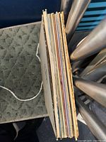 Stack of approximately nine vinyl records viewed at spine edge