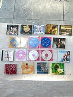 All 19 CDs laid out in four rows showing artwork and disc faces