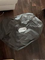 Top view of grey Carrier air conditioner cover on floor