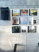 Front view of nine CD cases and black CD holder