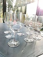 Group of ten crystal wine glasses on table