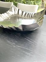 Overall view of polished stainless steel tray on table