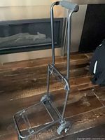 Full view of folded cart standing upright