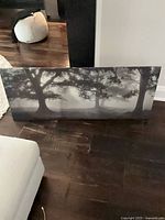 front view of misty forest canvas print leaning against wall