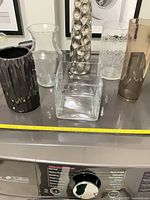 All six vases grouped showing sizes and materials