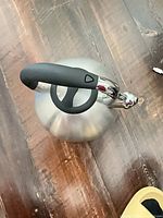 Top view of stainless steel kettle showing handle and lid