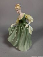 Front angled view of Royal Doulton Fair Lady figurine showing dress and facial detail