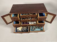 Overall view of jewelry box with drawers and jewelry visible