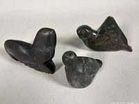 Three soapstone carvings: seal, small bird, larger wing-raised bird