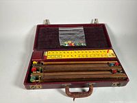 Closed maroon case open to show racks and chips bag