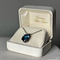 necklace in open box showing stone and chain