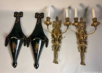 Full view of two brass sconces and two green lacquer wall planters