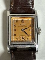 Close view of dial showing Tissot Aquasport branding, Arabic numerals and subsidiary seconds