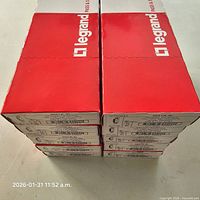 Stack of ten Legrand boxes with branding visible