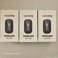 Front view of three boxed VicTsing PC269A mice