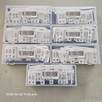 Seven storage cases containing silicone piano note label strips