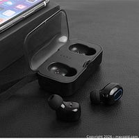 Earbuds and charging case shown open beside smartphone