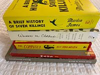 Stack of five books showing spines and titles