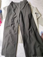 Charcoal pinstripe trousers over light grey tunic