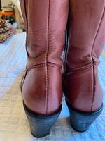 Rear view showing pinkish leather texture and heel