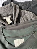 Close view of garment labels: Sarah Pacini, YAYA, and inside of herringbone jacket