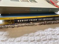 Side view of all four books showing spines and titles