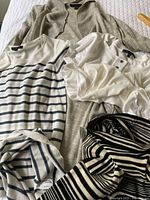 All four garments laid out together showing colors, patterns, labels