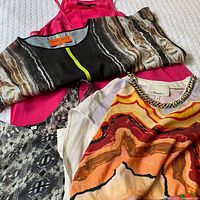 Four garments laid out showing prints and colours