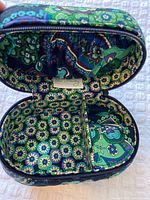 Interior view of quilted jewelry case showing floral paisley lining and Vera Bradley tag