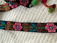 Close-up of central floral embroidery on black base