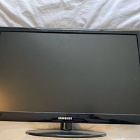 Front view of Samsung HDTV powered off on stand