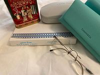 Group shot showing eyewear, cases, book, tin