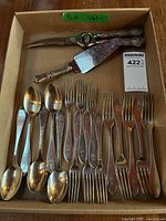 Box showing all flatware pieces including teaspoons, salad forks, dinner forks, cake server, poultry shears