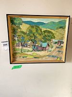 Full view of framed village landscape painting on wall