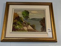 Framed oil painting on wall showing full view