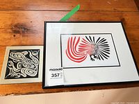 Both prints side by side, one framed owl print and one unframed wolf print