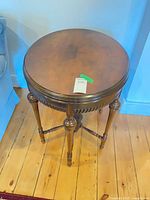 Full view of round wooden side table from top angle