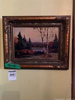 Framed painting on wall showing full view with scale tag