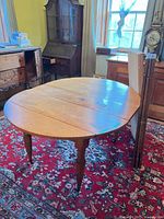 Full view of table set up oval with three leaves standing upright