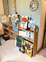 Front view of wooden shelving unit with shelves and decor items showing overall design