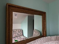 Full view of mirror mounted on wall showing frame detail and proportion