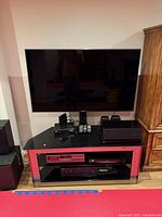 Front view of Samsung 55" TV mounted on Bello glass stand