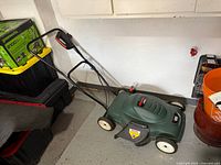 Side view of Black & Decker 18" corded electric lawn mower with handle extended