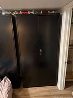 Front view of black steel filing cabinet