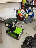 Front and side view of the Greenworks snow blower showing handle and chute
