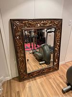 Front view of the Ren-Wil carved wood framed mirror