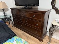 Front view of Millennium by Ashley dresser showing seven drawers and hardware